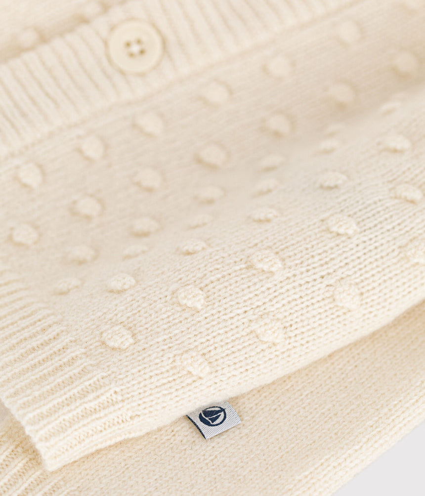 KNITTED CARDIGAN CONTAINING WOOL FOR BABIES.